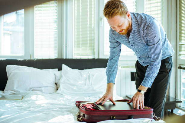 istock Businessman packing laptopt in the suitcase 673104794