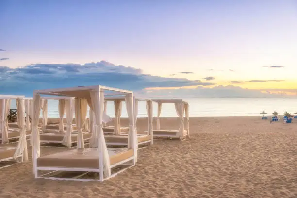 Four-poster tanning beds on the beach