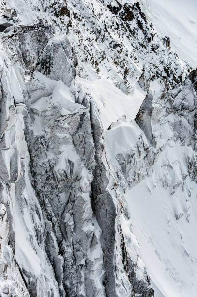 istock Snow covered cliffs and glacier crevasses in winter 673113710