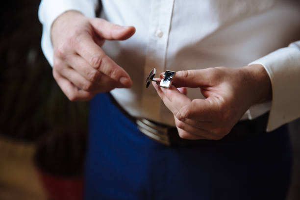 istock Groom hands with cufflinks. Elegant gentleman clother, white shirt 673114528