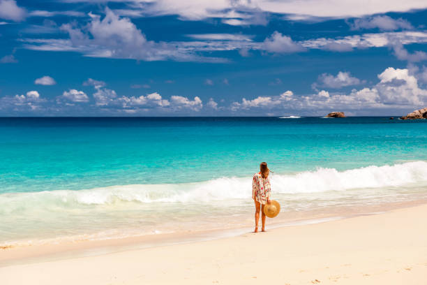 istock Woman with sarong on beach at Seychelles 673114542