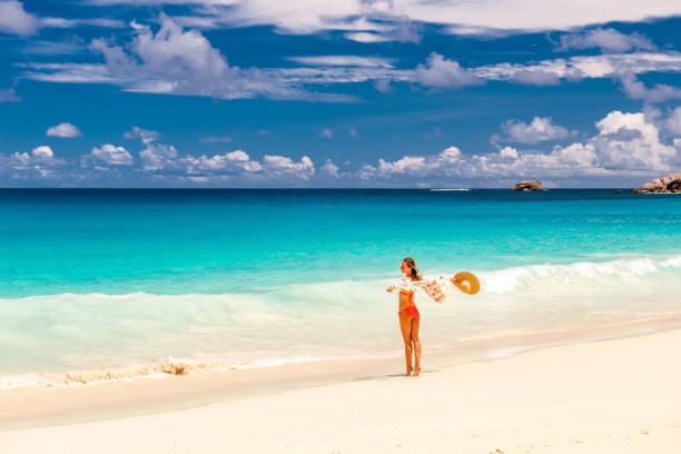istock Woman with sarong on beach at Seychelles 673114546