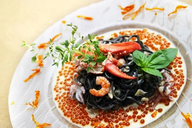 Black pasta with lobster cream sauce and caviar