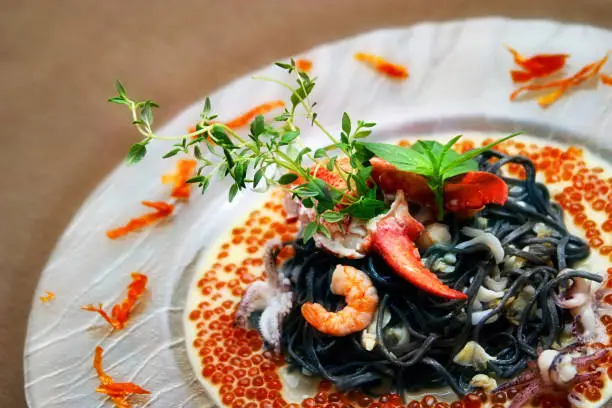 Black pasta with lobster cream sauce and caviar