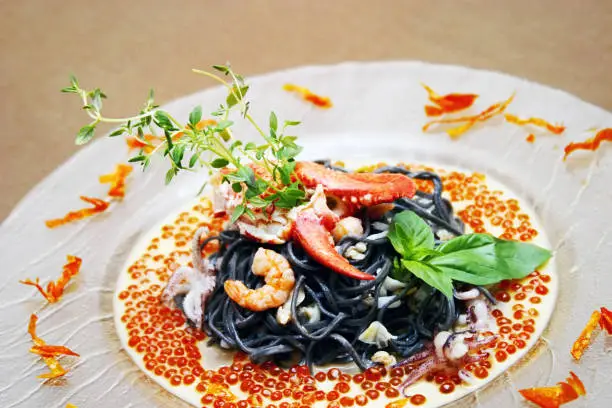 Black pasta with lobster cream sauce and caviar