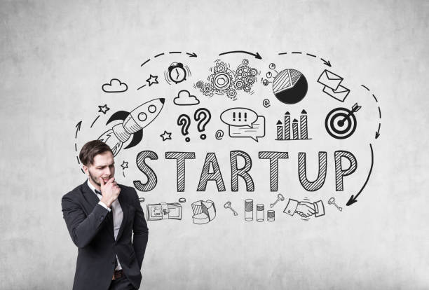istock Pensive man and startup on concrete 673117670