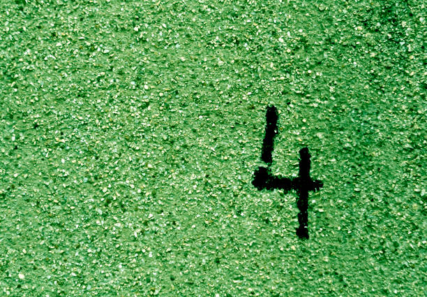 istock Number four on grungy green cement wall. 673118052