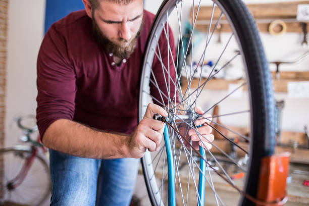 istock Technician fixing bicycle in repair shop 673120266