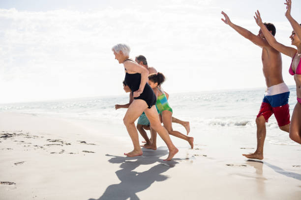 istock Happy family running on beach 673123942