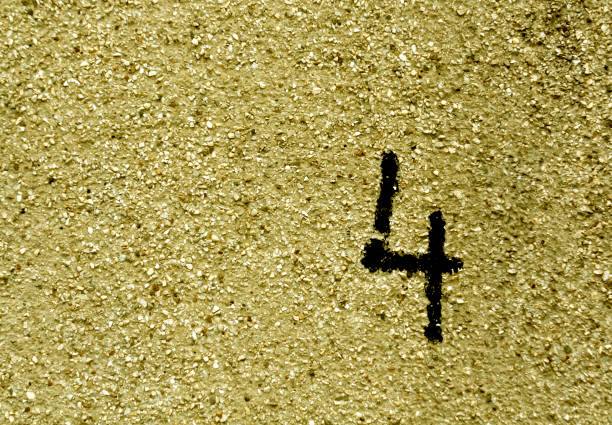 istock Number four on grungy yellow cement wall. 673129270