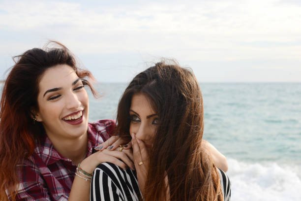 istock gossip girls smiling on the beach 673129334