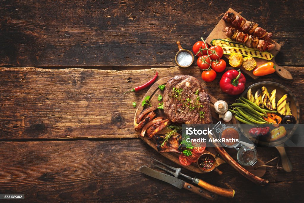 Grilled meat and vegetables Grilled meat and vegetables on rustic wooden table Barbecue Grill Stock Photo