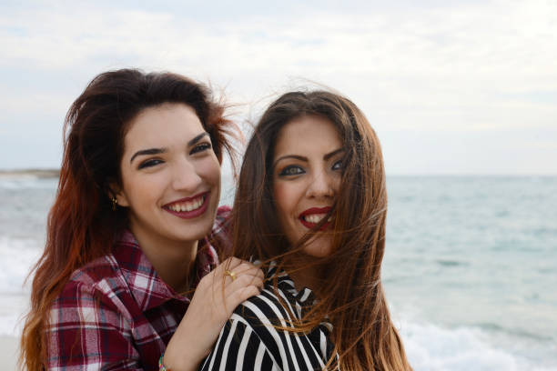 istock gossip girls smiling on the beach 673145408