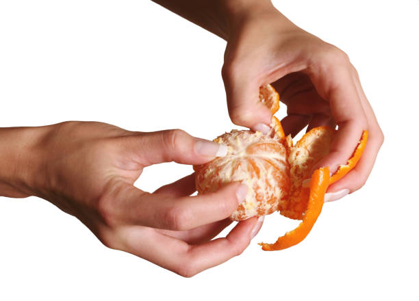 istock Female hands clean a tangerine 673145880