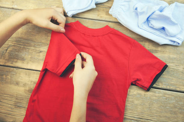 istock A pregnant woman folding baby clothes 673146416