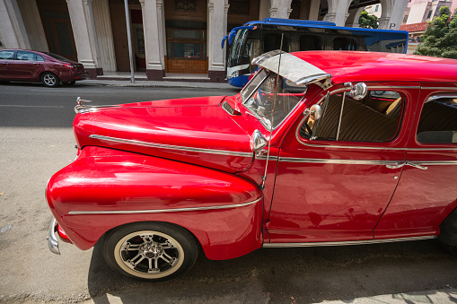 Old red vintage car in the streets of Havana