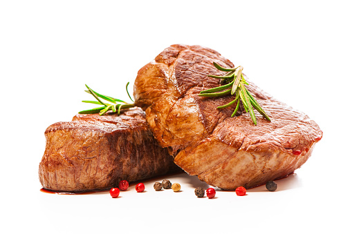 Grilled beef fillet steaks with spices isolated on white background