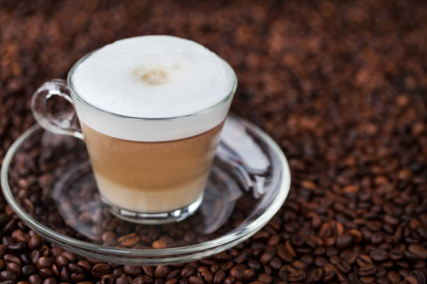 istock Cup of fresh hot latte on coffee bean background 673158798