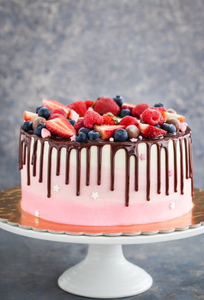 istock Homemade pink cake decorated with chocolate and  fresh berries 673158966