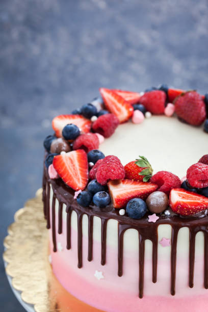 istock Homemade pink cake decorated with chocolate and  fresh berries 673158984