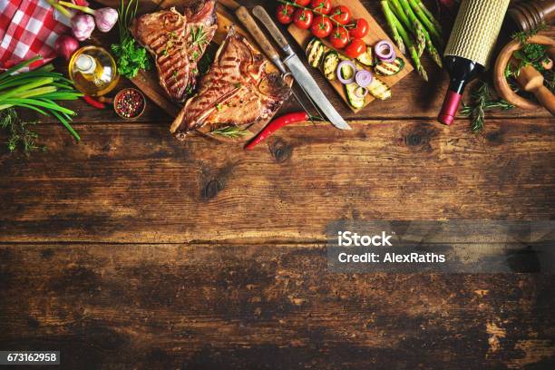 Grilled Tbone Steaks With Fresh Herbs Vegetables Ans Wine Bottle Stock Photo - Download Image Now