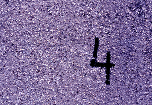 Number four on grungy blue cement wall.