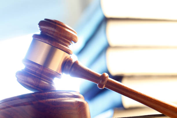 istock Gavel In Front Of Stack Of Law Books 673165996