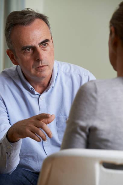 istock Depressed Mature Man Talking To Counsellor 673166524