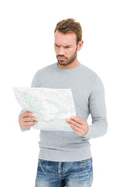 young man looking at map - explorer tourist frowning men imagens e fotografias de stock