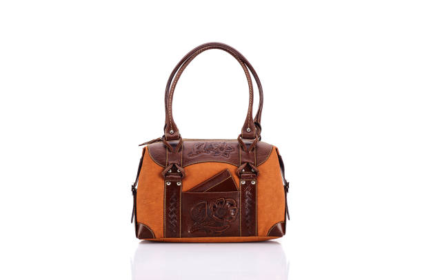 Leather ladies bag on a white background. Beautiful, fashionable, accessory, isolated. Interesting design, the texture of the skin. Comfortable handle.Leather ladies bag on a white background. Beautiful, fashionable, accessory, isolated. Interesting design, the texture of the skin. Comfortable handle.