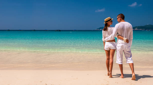 istock Couple in white on a beach 673173530