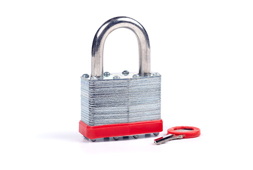 Steel padlock with key on a white background