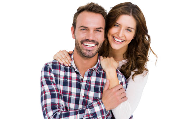 Portrait of young couple smiling Portrait of young couple smiling on white background two people embracing stock pictures, royalty-free photos & images