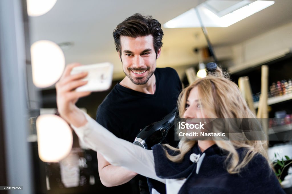 Selfie with hairdresser Hairdresser taking selfie with customer Hairdresser Stock Photo