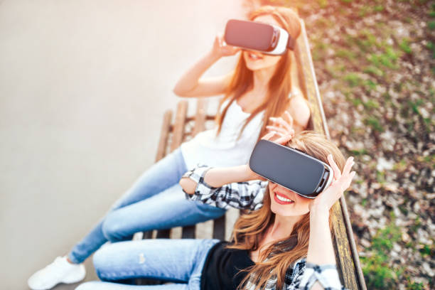 istock Two young girls enjoy virtual reality glasses 673179990