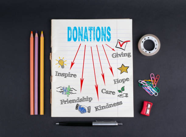 donations concept. on a black background copybook, pencils, pen, adhesive tape and paper clips - blood bank imagens e fotografias de stock