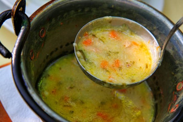 istock Pig-iron saucepan with vegetable soup and a scoop 673183354