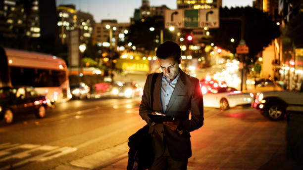 digital tablet at night in the city. - india car people business imagens e fotografias de stock