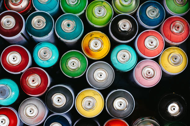 istock Cluster of spray paint cans, from abve 673183790
