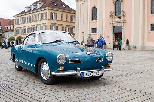 Prague, Czech Republic - June 27, 2019: View of Landmark architecture building call name Powder tower(Prasna brand) in the centre city with old retro car for excursion  tour in sunny day on blue sky background.