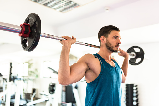 man with barbell in the gym