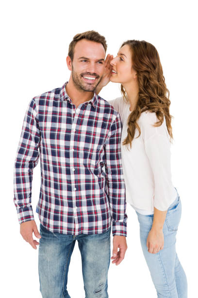 istock Woman whispering into mans ears 673196654