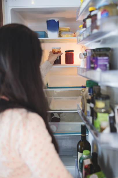 istock Woman checking food in refrigerator 673199954