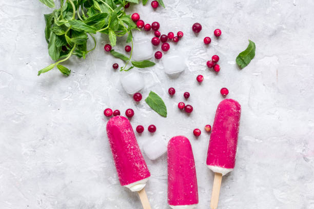 istock summer dessert with popsicle and red berries stone desk background top view 673206016
