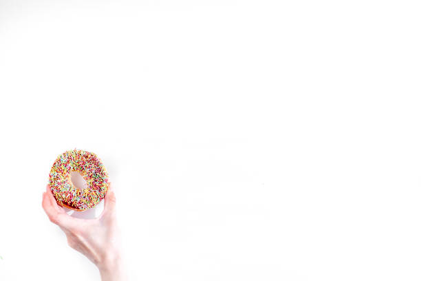chocolate donut in hand on white background top view space for text