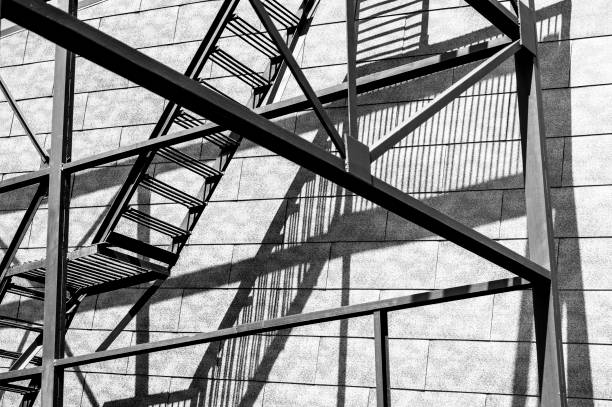istock Shadows from the iron staircase on the wall 673209370