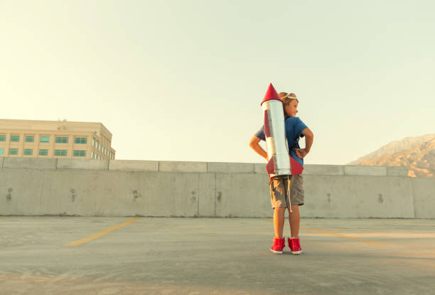 istock Young Boy Dreams of Flying with Rocket 673209542