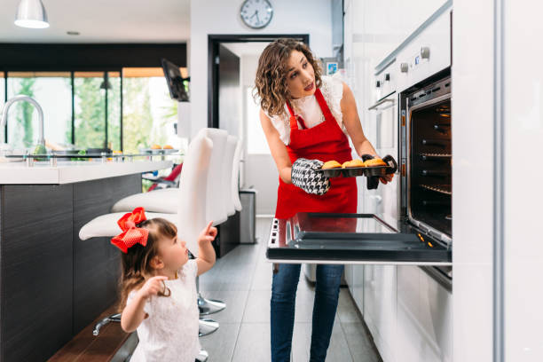istock Mother and Daughter Baking Muffins 673210644