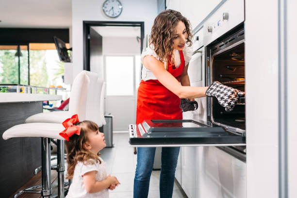 istock Mother and Daughter Baking Muffins 673210660
