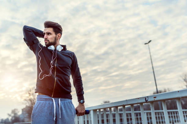 istock Man Runner Under Bridge in the City Taking Brake 673213154